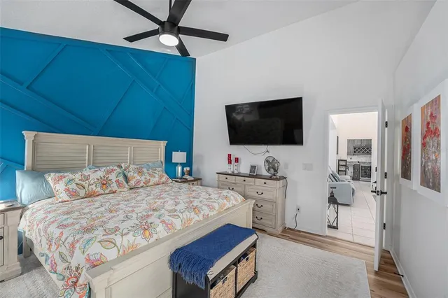 a bedroom with a bed and a flat screen tv