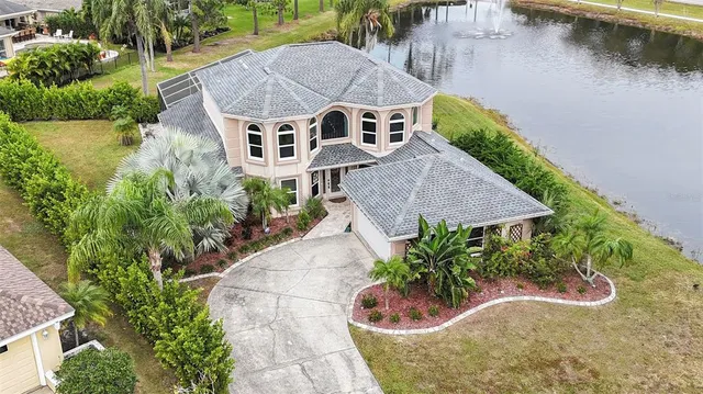 an aerial view of a house with a yard