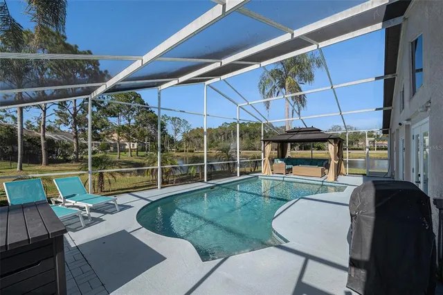 a view of a patio with table and chairs under an umbrella