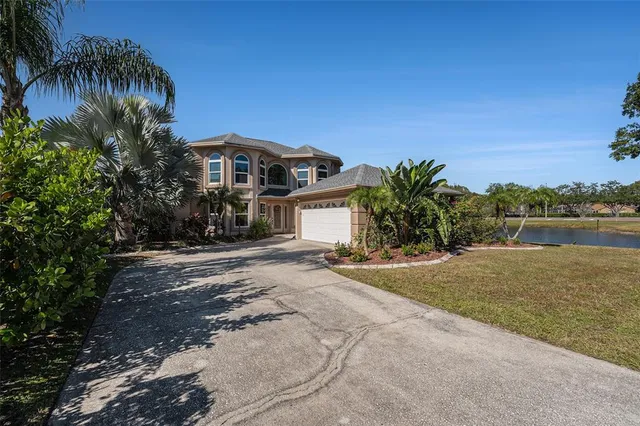 a front view of a house with a yard and mountain view