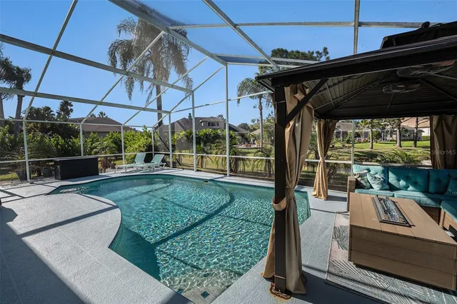 a view of a patio with a table chairs and a tub