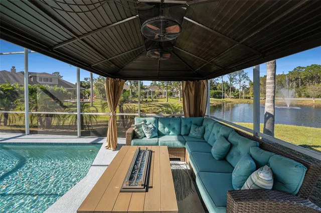 a view of a porch with furniture and a yard