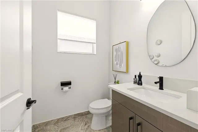 a bathroom with a toilet sink and mirror
