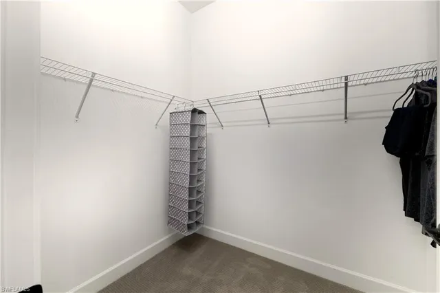 a view of walk in closet with clothes