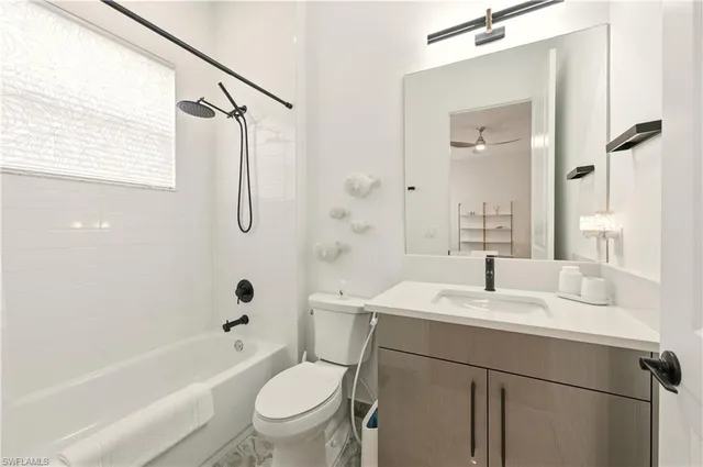 a bathroom with a sink a toilet and a bathtub