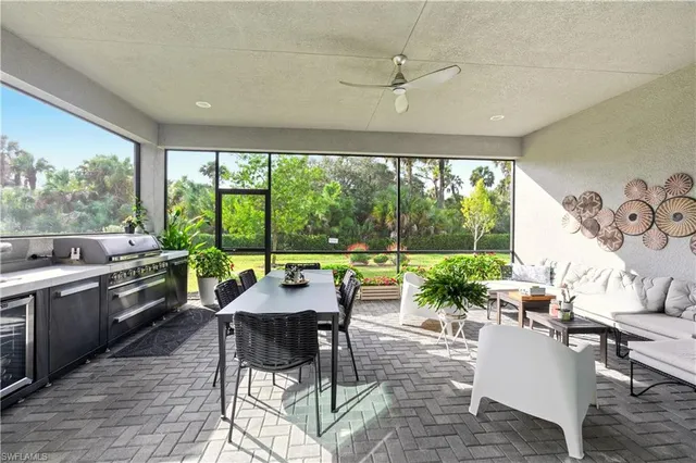 a dining room with furniture a large window and a rug