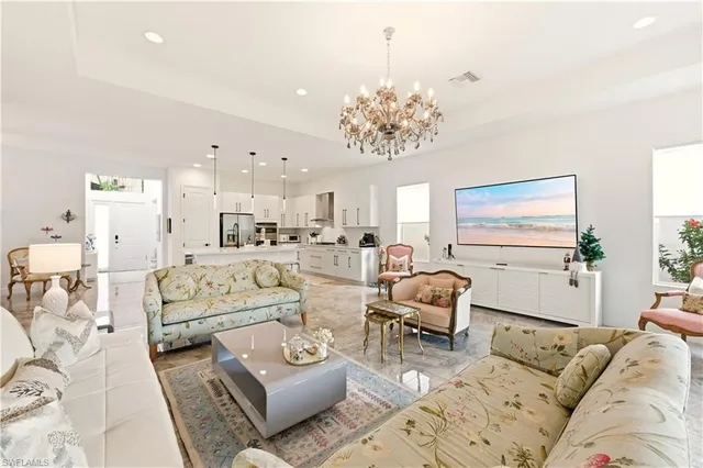 a living room with furniture and a chandelier