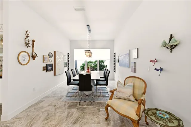 a living room with furniture a table and a chandelier
