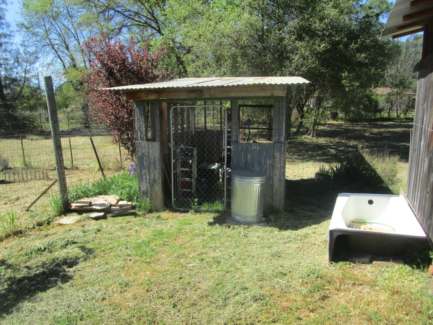 10410 Valley Drive Rough and Ready, CA 95975 - Photo 12 of 31 a view of a two chair under an umbrella in front of house