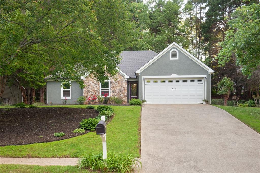 1605 Barrier Road Marietta, GA 30066 - Photo 1 of 1 a front view of a house with a yard and garage
