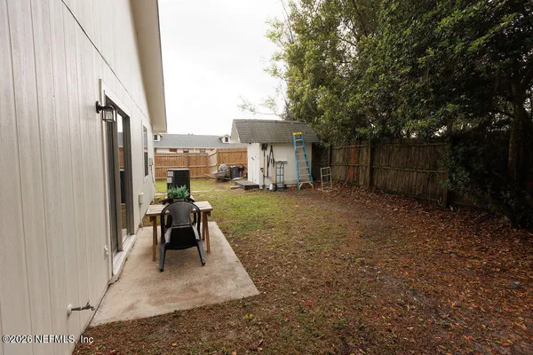 a view of a porch with chairs and a yard