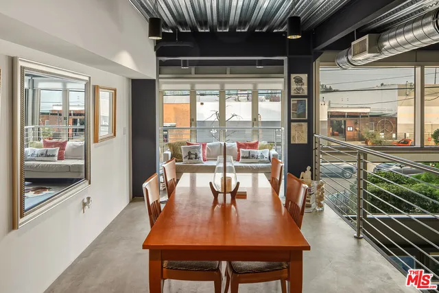 a dining room with furniture a chandelier and wooden floor