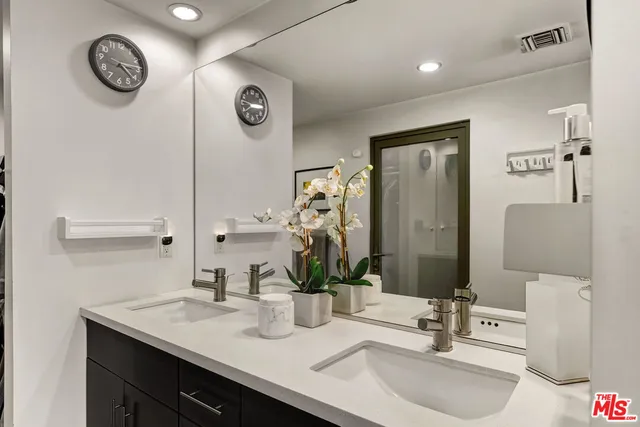 a bathroom with a sink vanity and a mirror