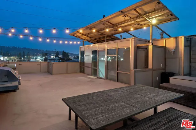a view of a terrace with furniture and a yard