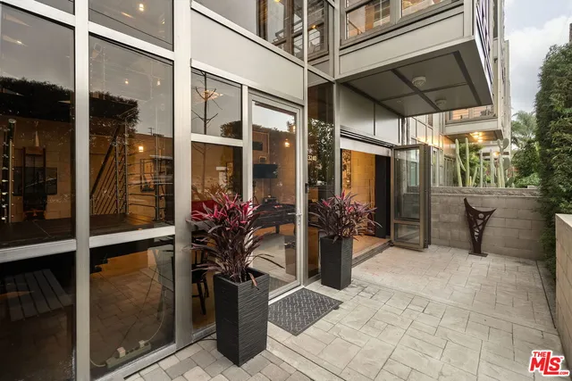 a view of a porch with a table and chairs