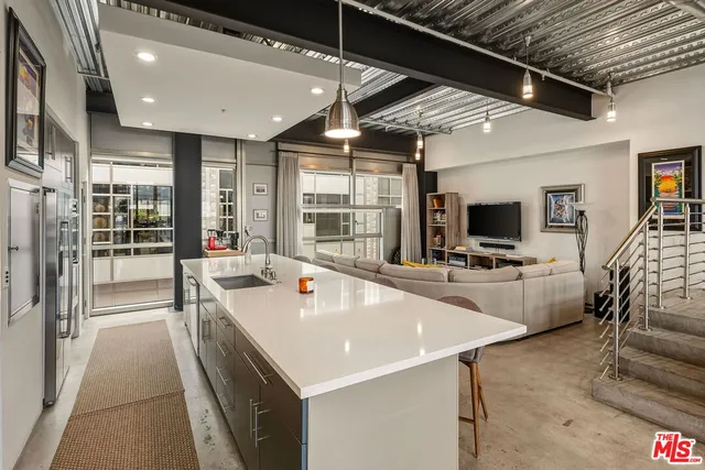 a large white kitchen with a large window