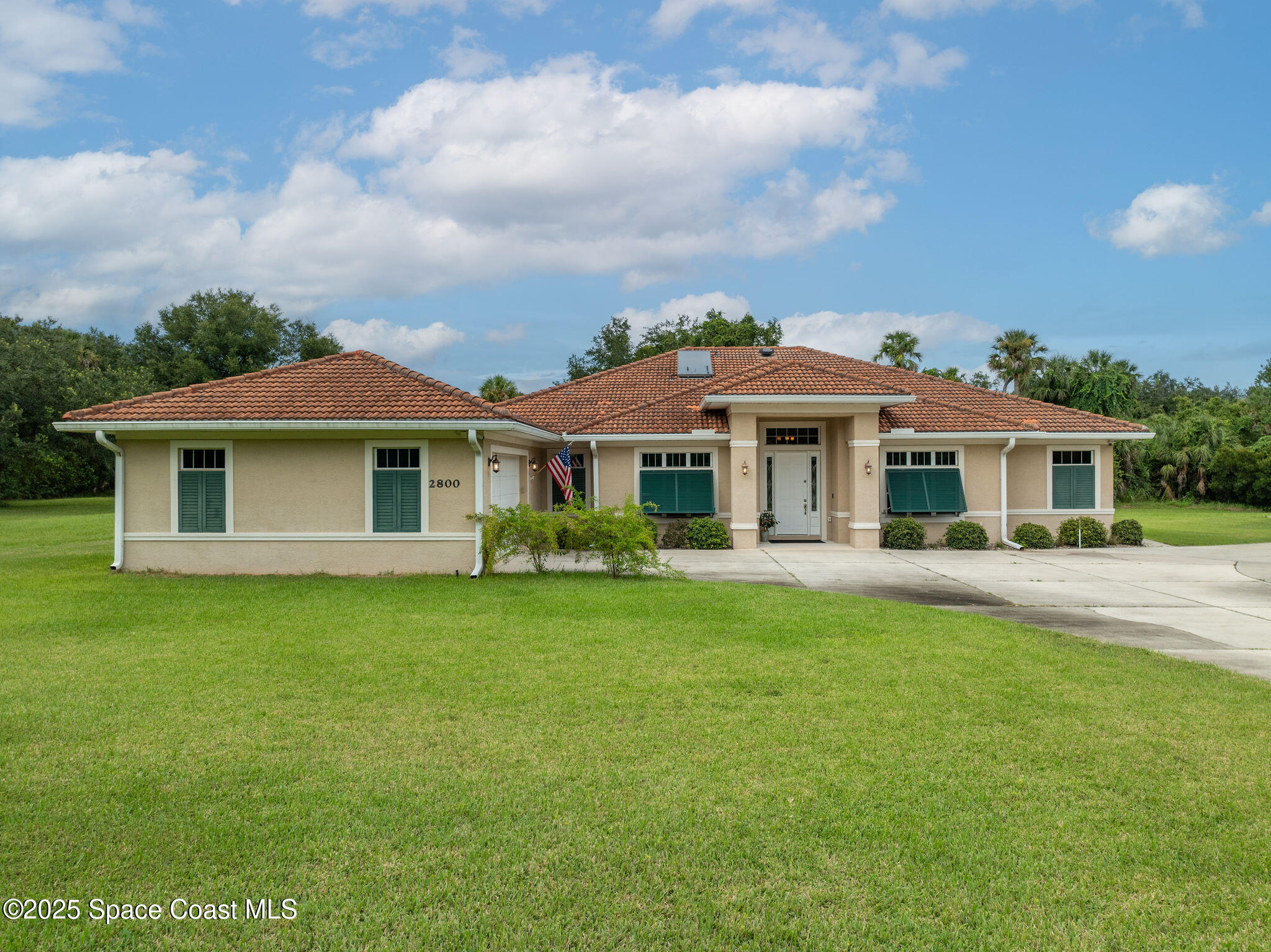 2800 Parrish Road Titusville, FL 32796 - Photo 1 of 45 a front view of a house with a garden