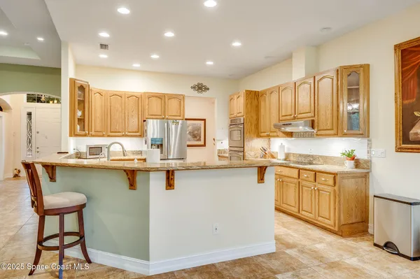 a kitchen with stainless steel appliances granite countertop a sink counter space and cabinets