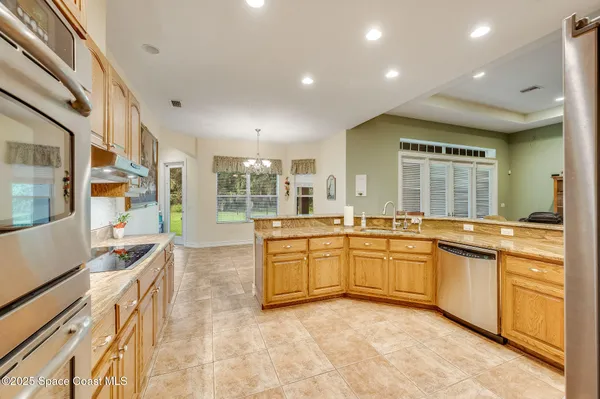 a kitchen with stainless steel appliances granite countertop a refrigerator sink and stove