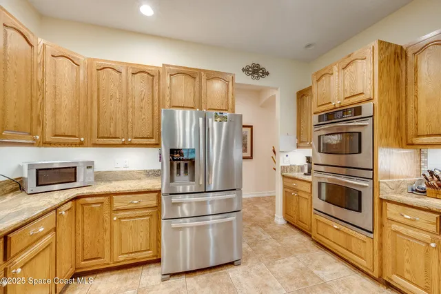 a kitchen with stainless steel appliances a refrigerator sink and cabinets