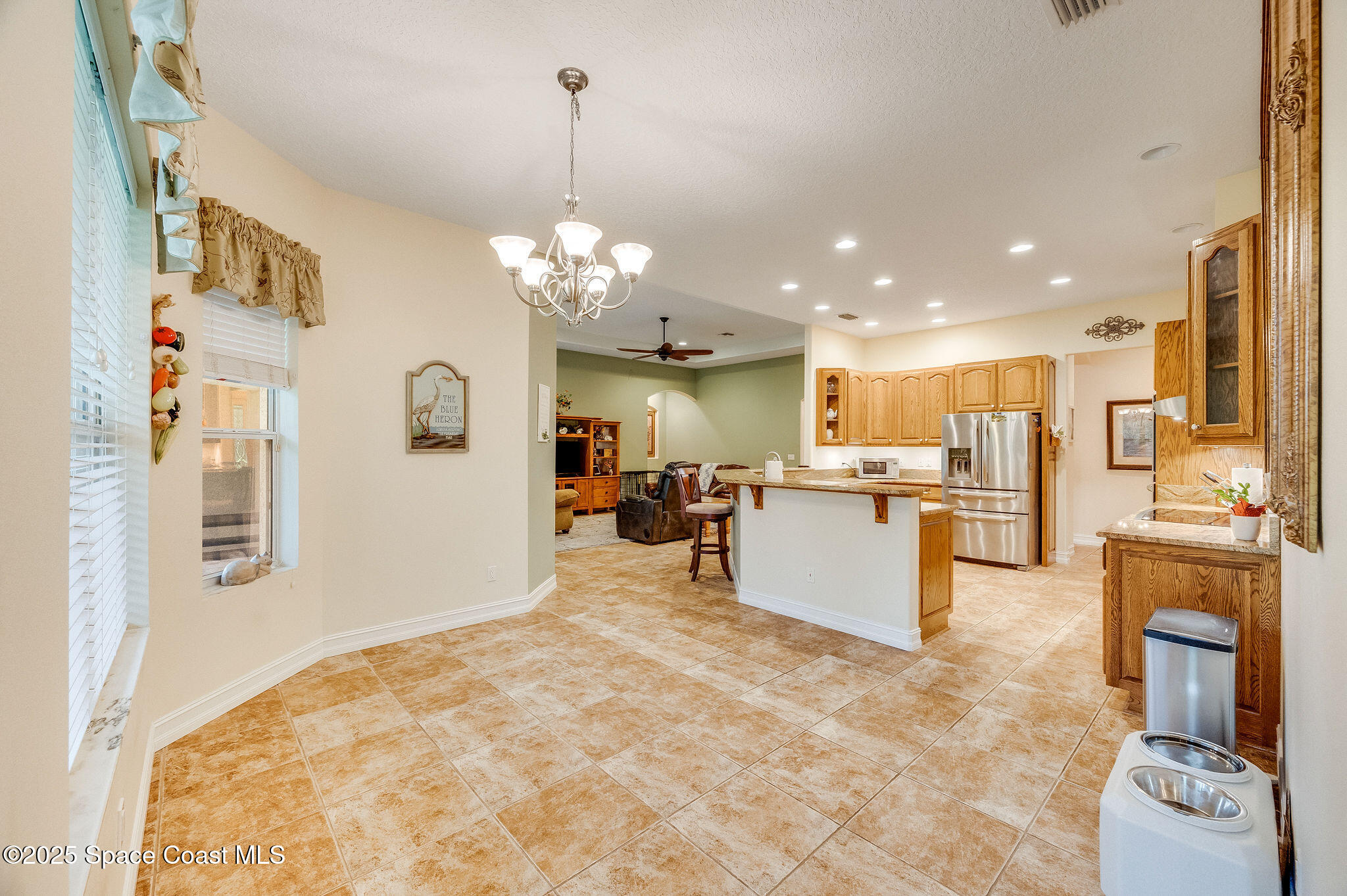 2800 Parrish Road Titusville, FL 32796 - Photo 18 of 45 a view of a kitchen with kitchen island stainless steel appliances microwave stove refrigerator and cabinets