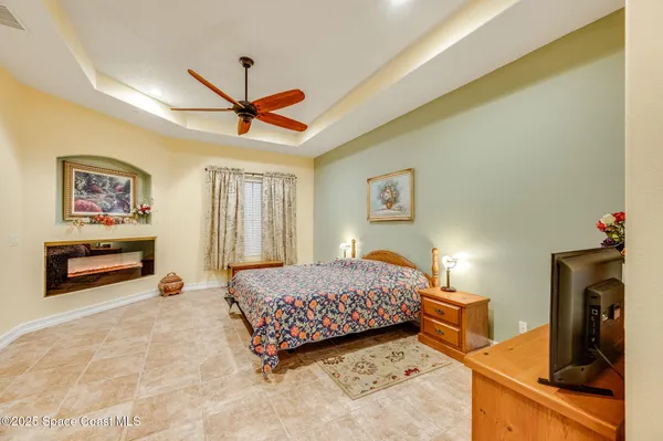 a bedroom with a bed and a chandelier