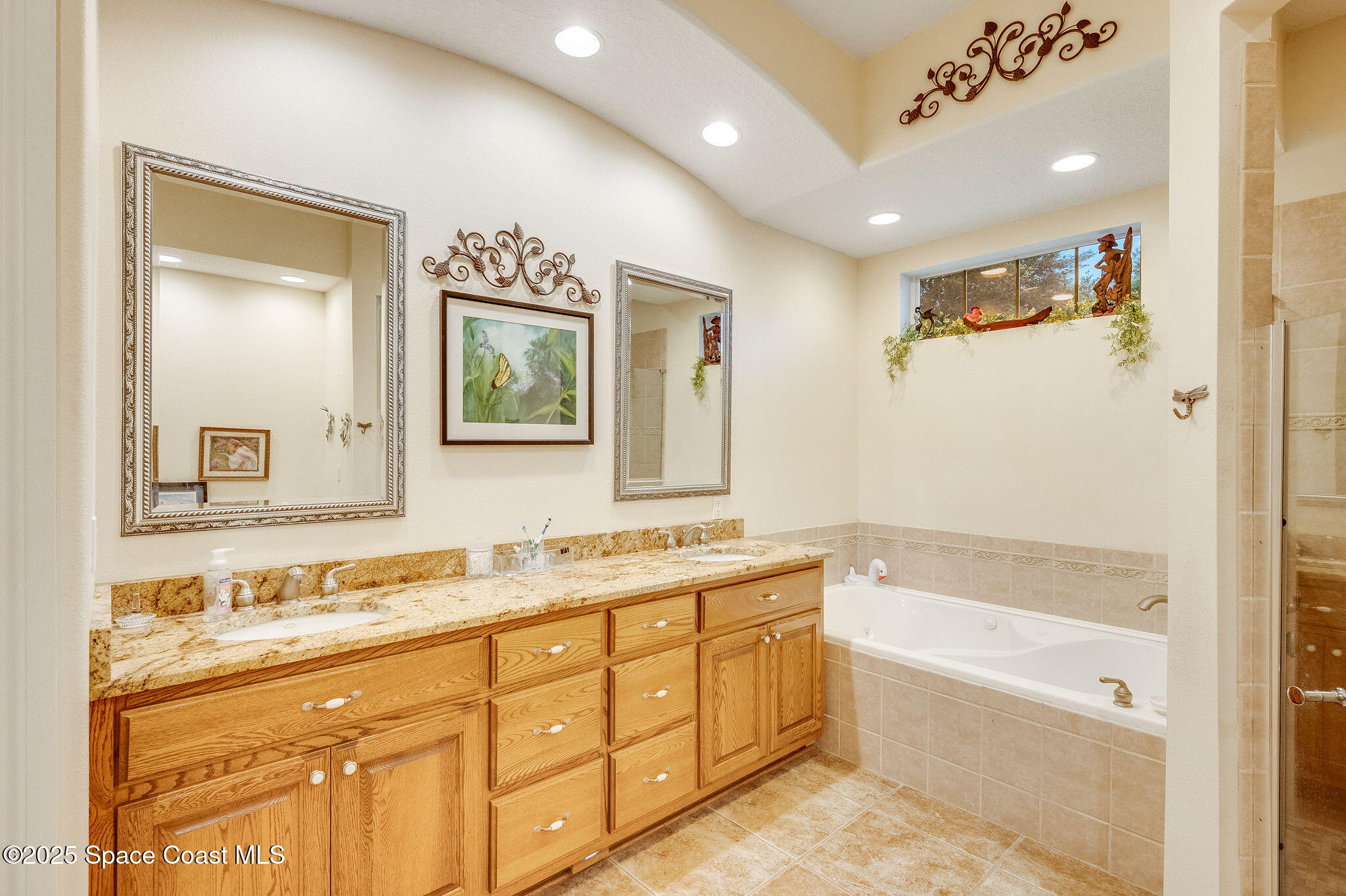 2800 Parrish Road Titusville, FL 32796 - Photo 24 of 45 a bathroom with a tub a sink and a mirror