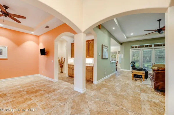 a view of a livingroom with wooden floor and furniture