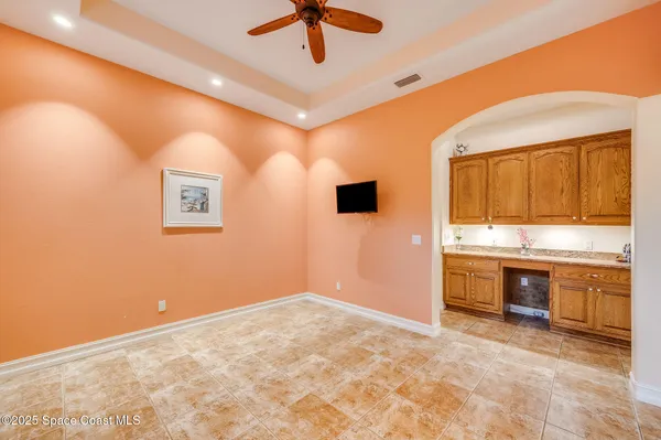 a kitchen with stainless steel appliances granite countertop a sink a stove a refrigerator cabinets and chairs
