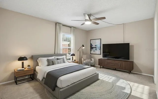 an empty room with windows and fan