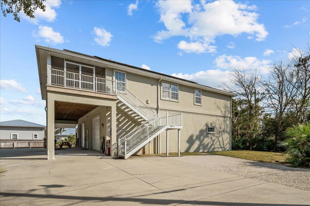 736-8 Kings Estate Road St. Augustine, FL 32086 - Photo 2 of 40 Rear view of house with concrete driveway, stucco siding, and an attached garage