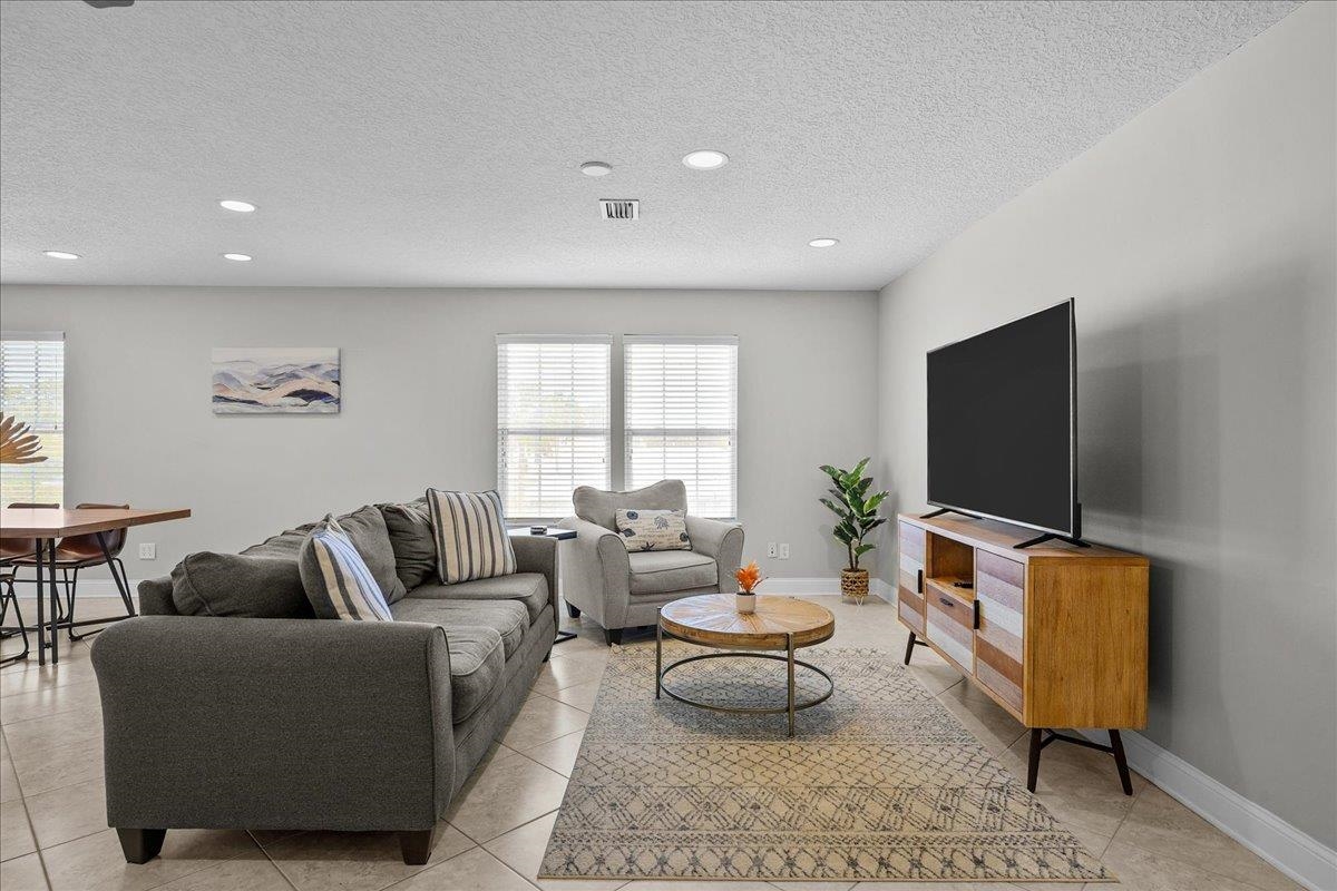 736-8 Kings Estate Road St. Augustine, FL 32086 - Photo 21 of 40 Living room with a textured ceiling, recessed lighting, and light tile patterned floors
