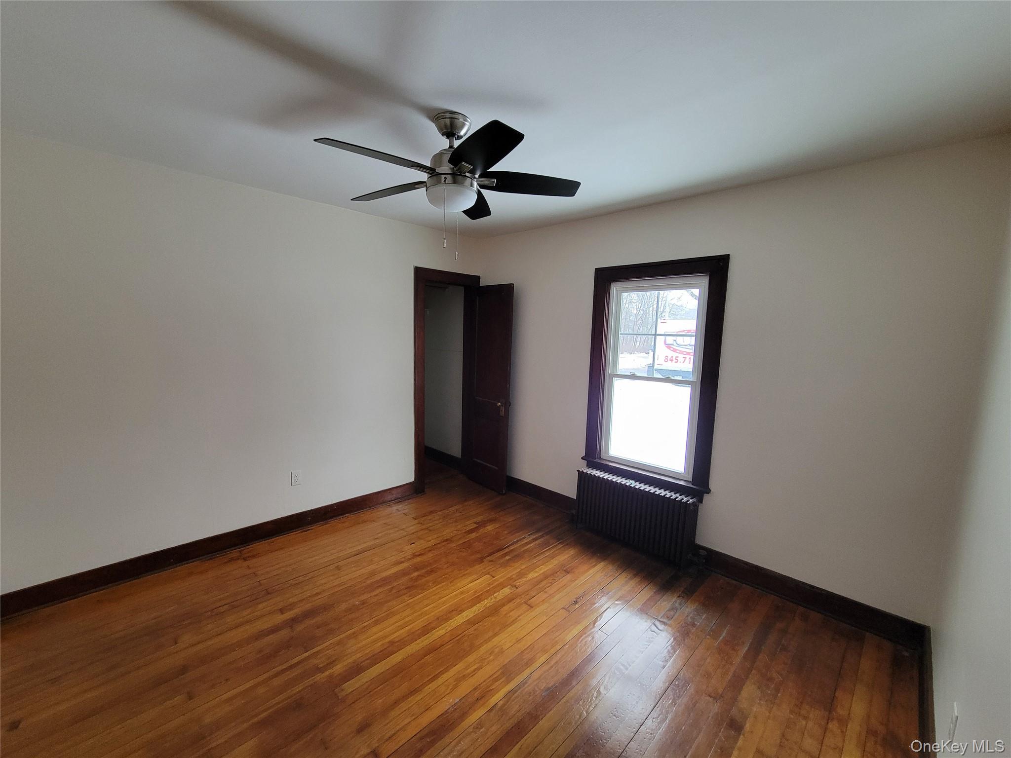 712 State Route 52 Walden, NY 12586 - Photo 16 of 21 a view of empty room with wooden floor and fan
