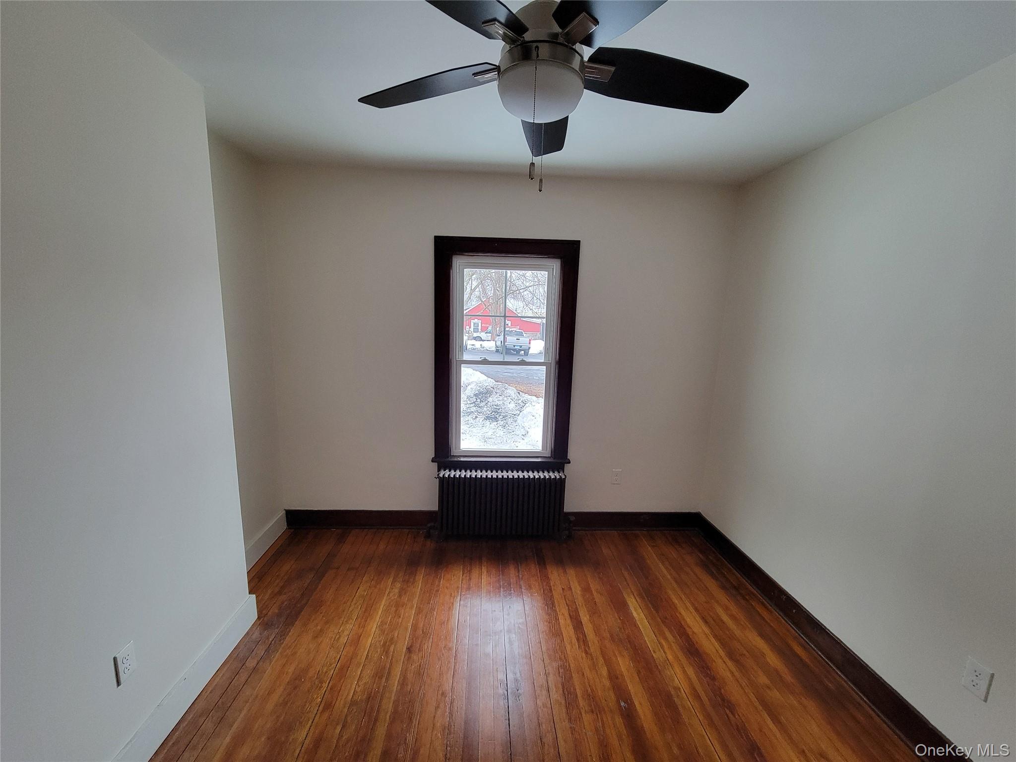 712 State Route 52 Walden, NY 12586 - Photo 17 of 21 a view of an empty room with wooden floor and a window
