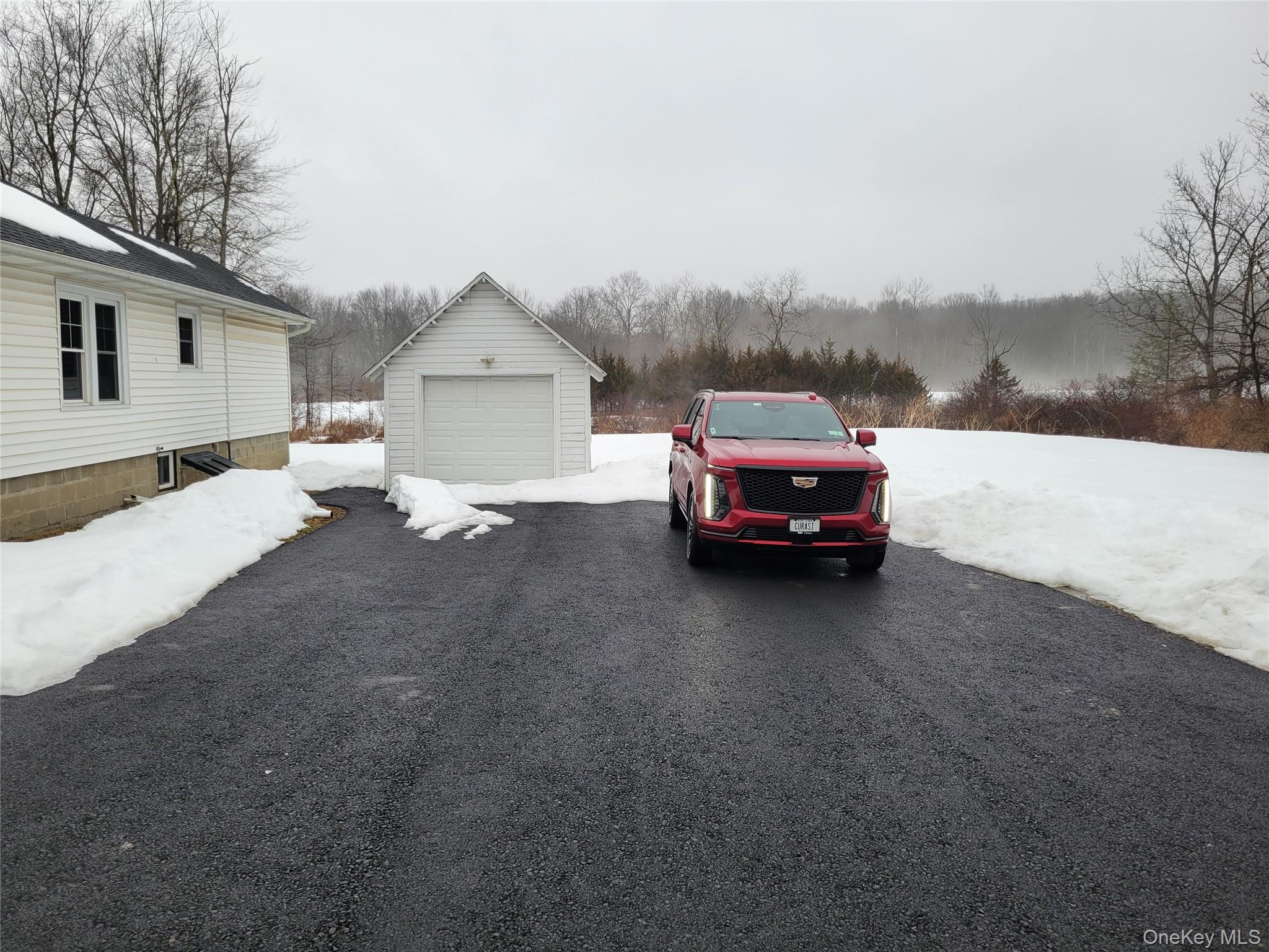 712 State Route 52 Walden, NY 12586 - Photo 3 of 21 a car parked in front of a house next to a yard
