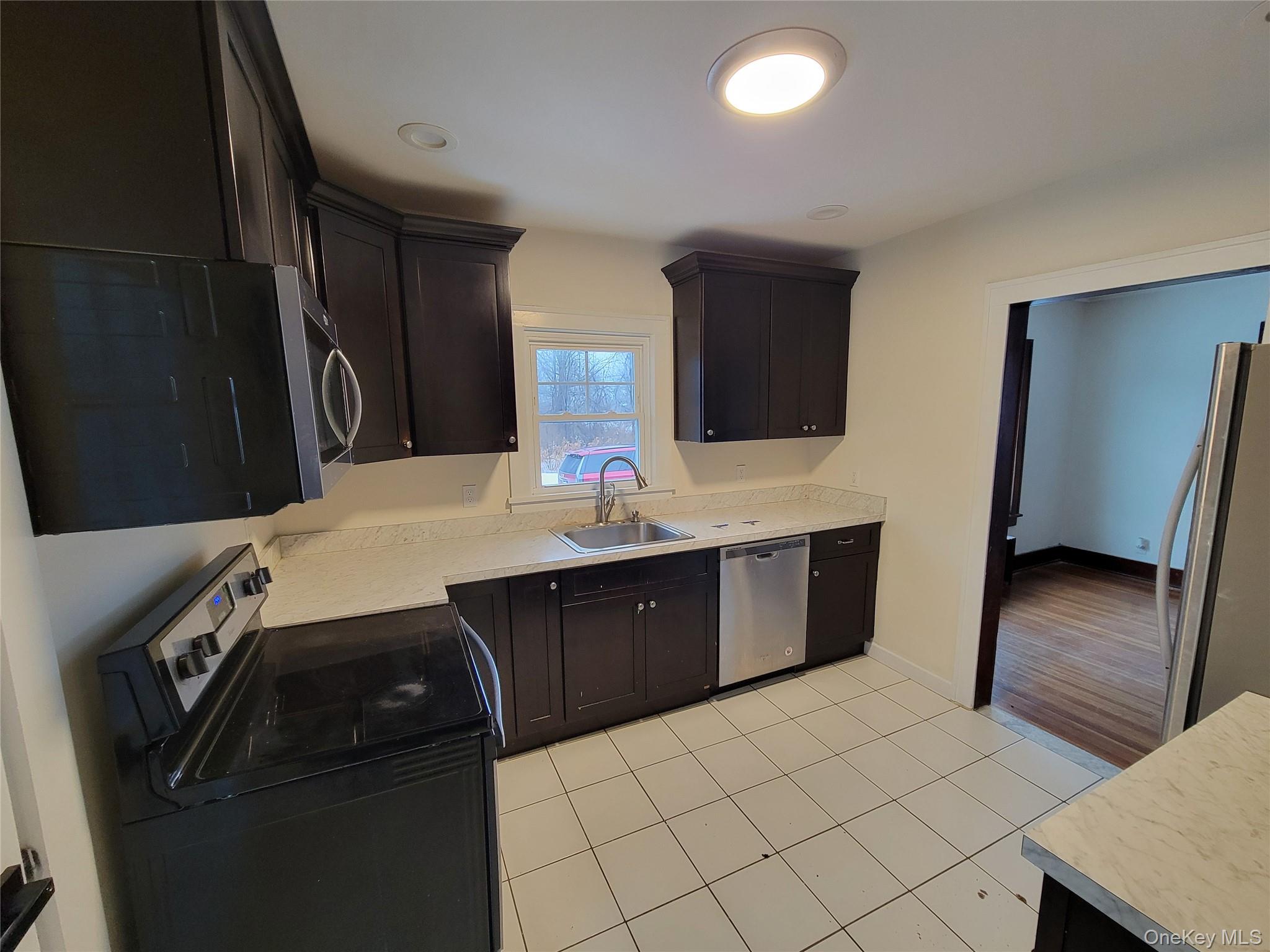 712 State Route 52 Walden, NY 12586 - Photo 4 of 21 a kitchen with a sink a refrigerator and cabinets