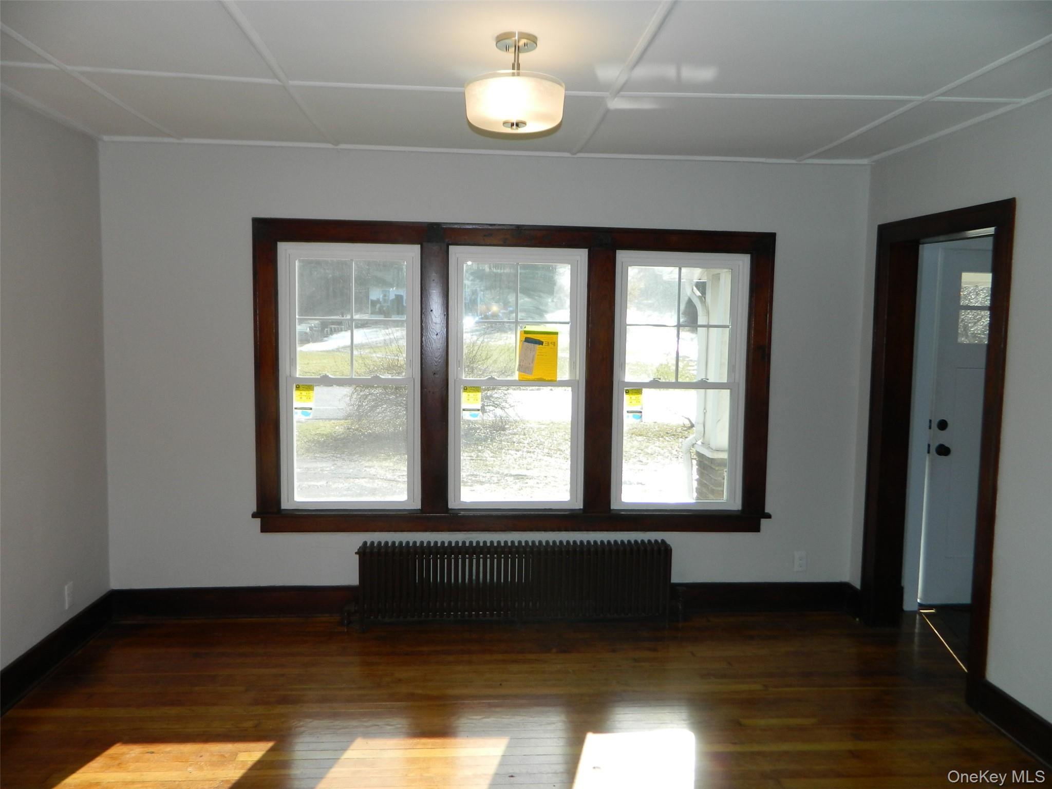 712 State Route 52 Walden, NY 12586 - Photo 7 of 21 a view of an empty room with wooden floor and a window