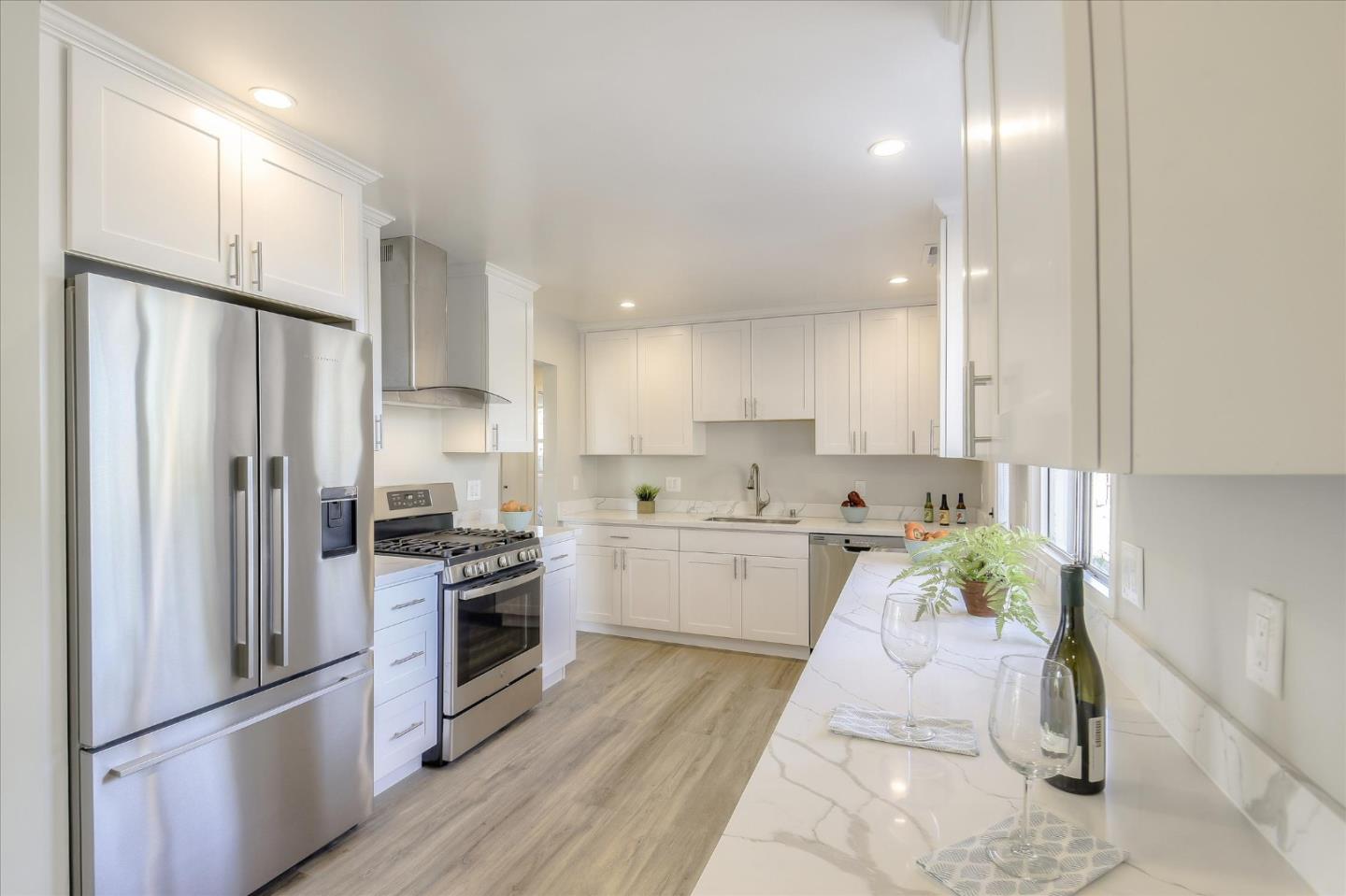 504 Arguello Boulevard Pacifica, CA 94044 - Photo 11 of 42 a kitchen with a refrigerator a sink and a stove top oven