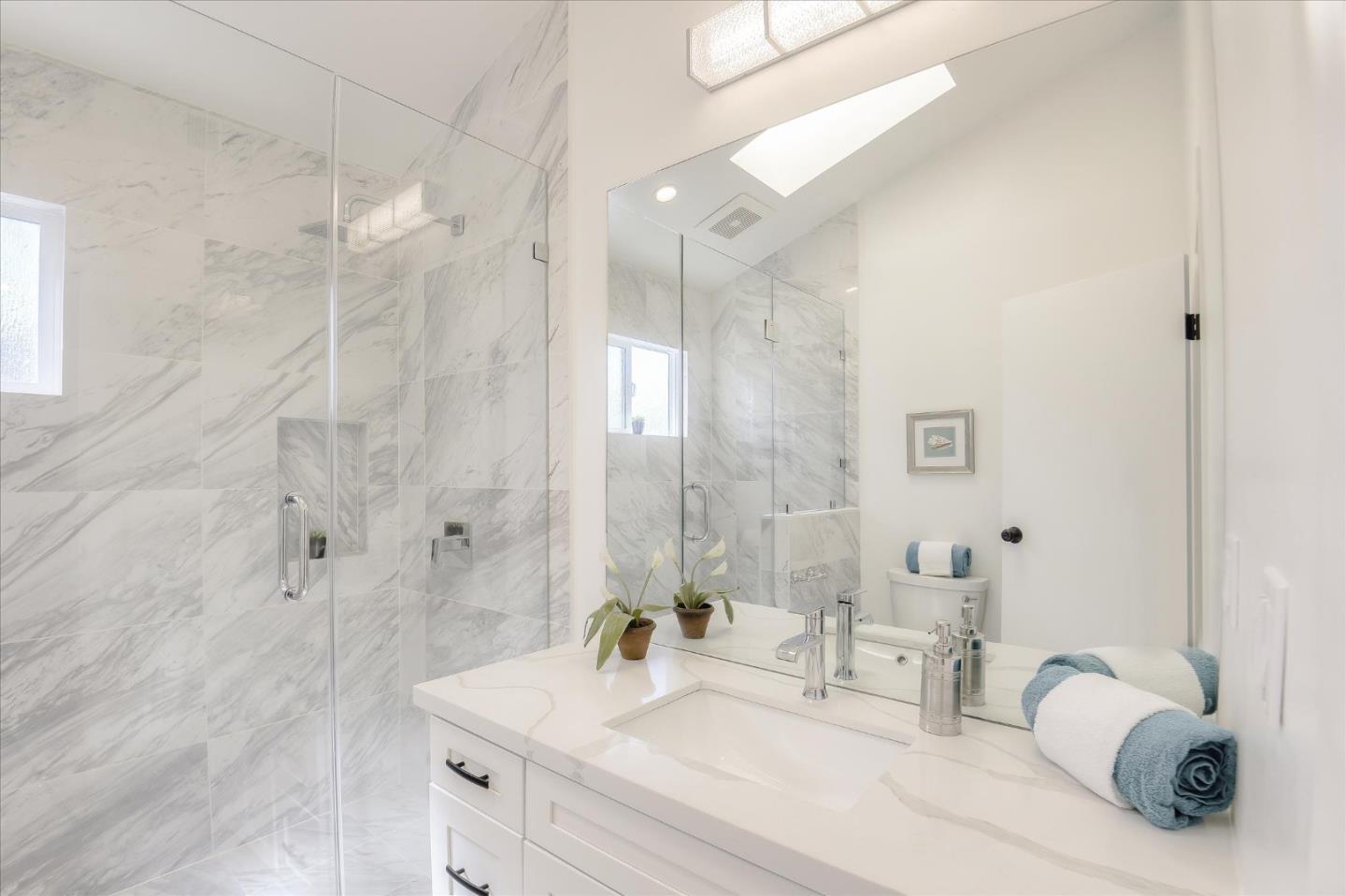504 Arguello Boulevard Pacifica, CA 94044 - Photo 23 of 42 a bathroom with a double vanity sink mirror and shower