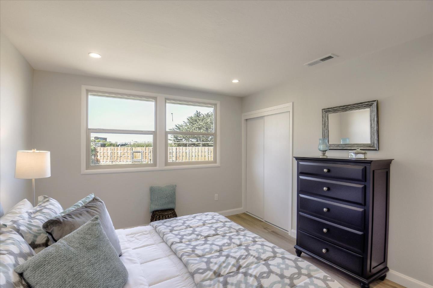 504 Arguello Boulevard Pacifica, CA 94044 - Photo 27 of 42 a bedroom with a bed and a window