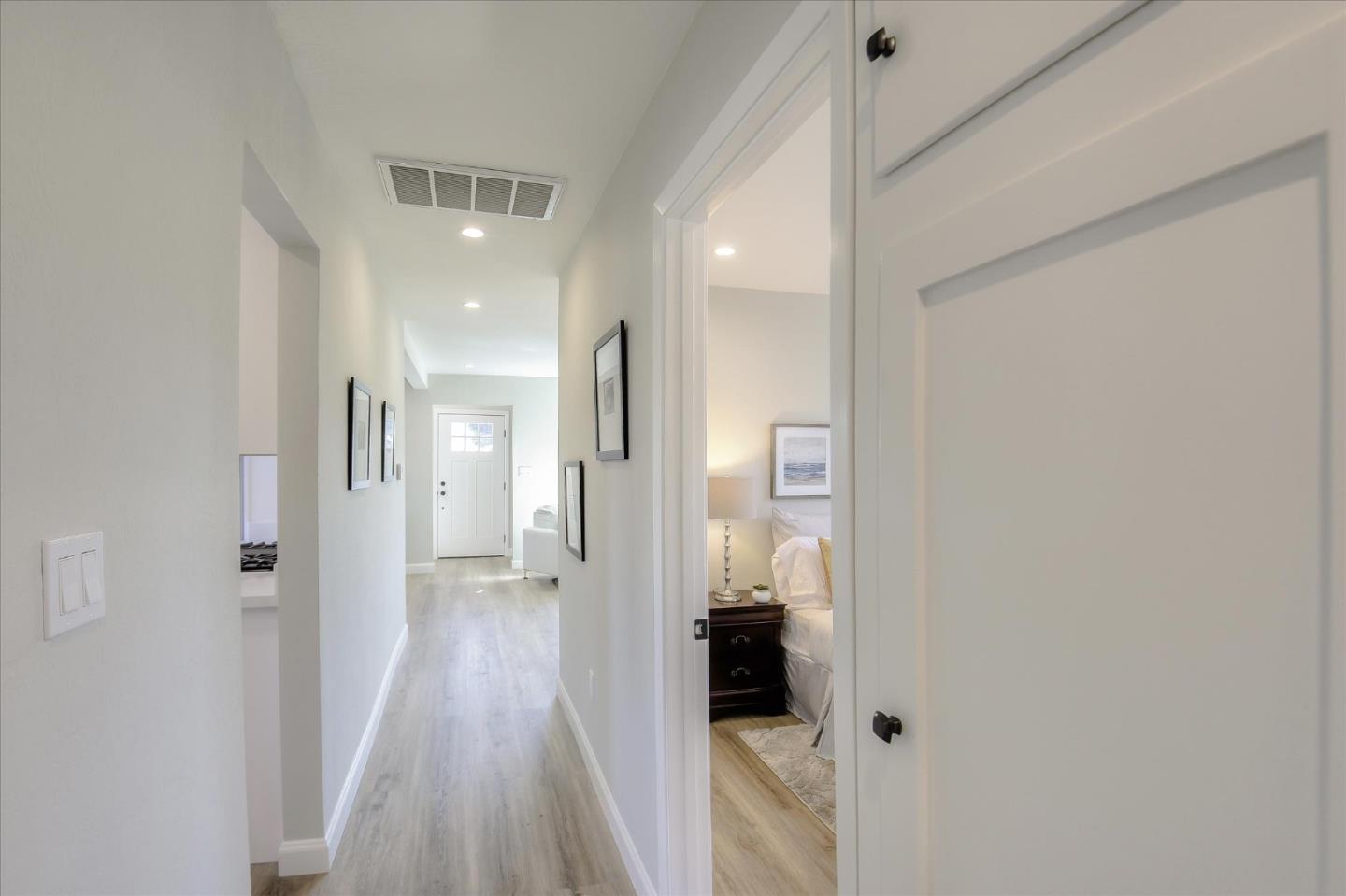 504 Arguello Boulevard Pacifica, CA 94044 - Photo 32 of 42 a view of a hallway with a hardwood floor and a kitchen