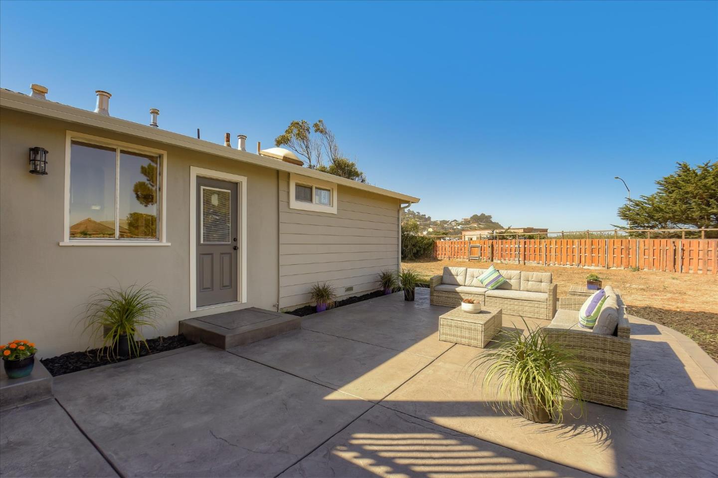 504 Arguello Boulevard Pacifica, CA 94044 - Photo 37 of 42 a view of a patio with couches chairs and potted plants
