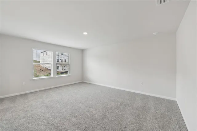 a spacious bedroom with a large bed and a couch