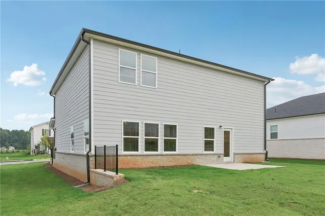 a backyard of a house with table and chairs