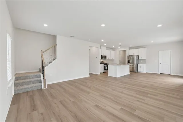 a view of kitchen with wooden floor and electronic appliances