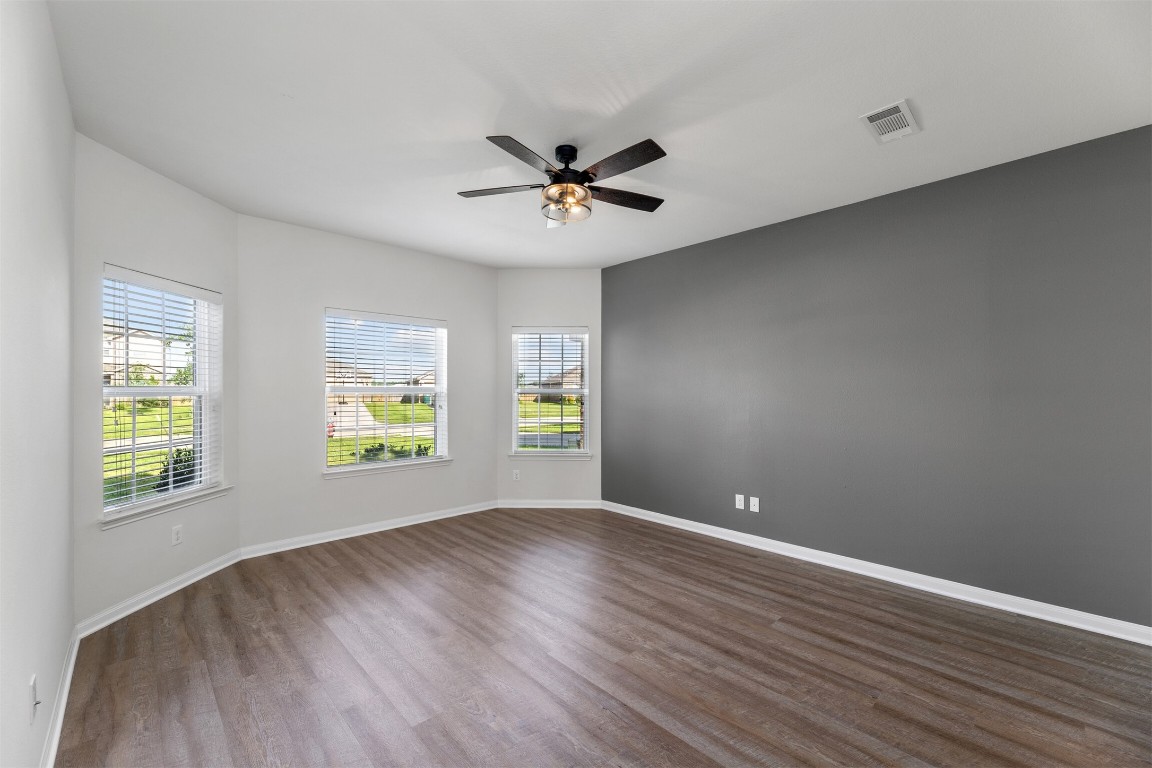 9715 Blue Sapphire Lane Rosharon, TX 77583 - Photo 12 of 30 Primary bedroom with vinyl flooring, suite with walk-in closet and large windows.