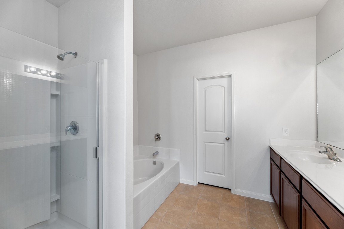 9715 Blue Sapphire Lane Rosharon, TX 77583 - Photo 14 of 30 Primary bathroom with separate soaking tub, large vanity and walk-in closest.