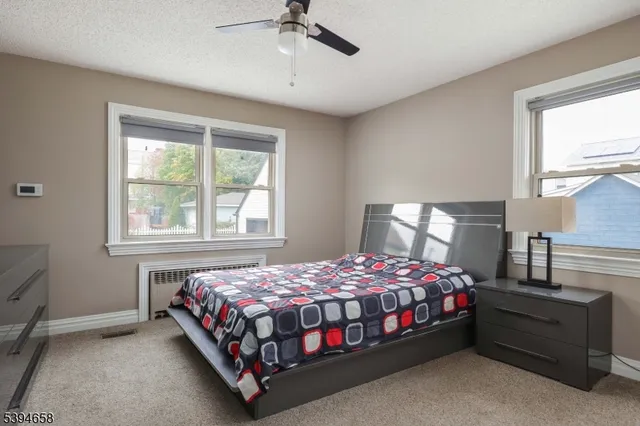 a bedroom with a bed lamp and a window