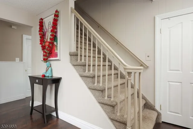 a view of entryway with furniture and wooden floor