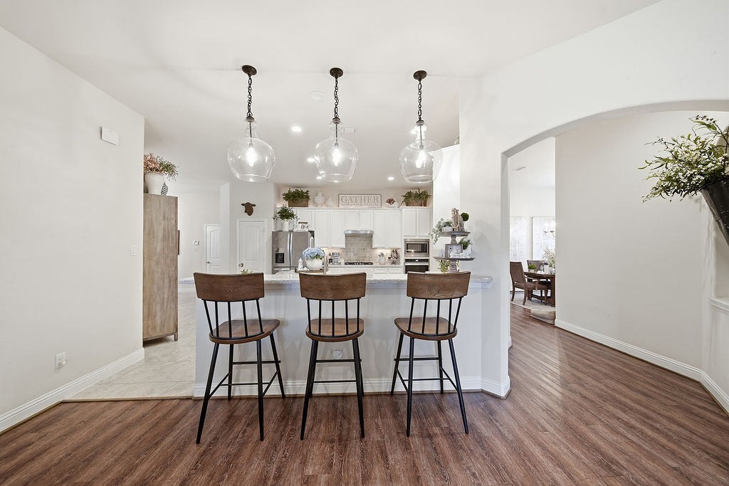 9614 Carson Lane Iowa Colony, TX 77583 - Photo 13 of 50 Sparkling updated pendant lighting showcasing the beautiful kitchen with quartz countertops!